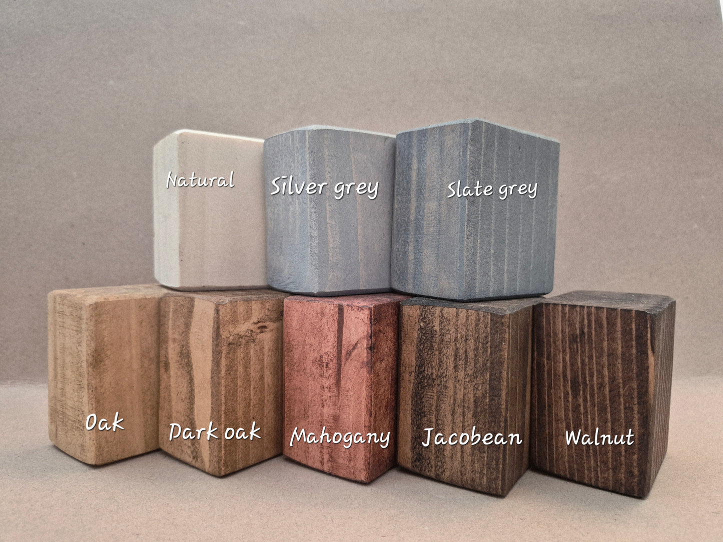 Eight finish sample blocks stacked together, labelled from Natural through to Walnut